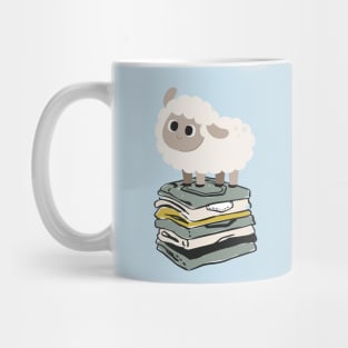 Cute Baby Sheep on top of folded clothes Mug